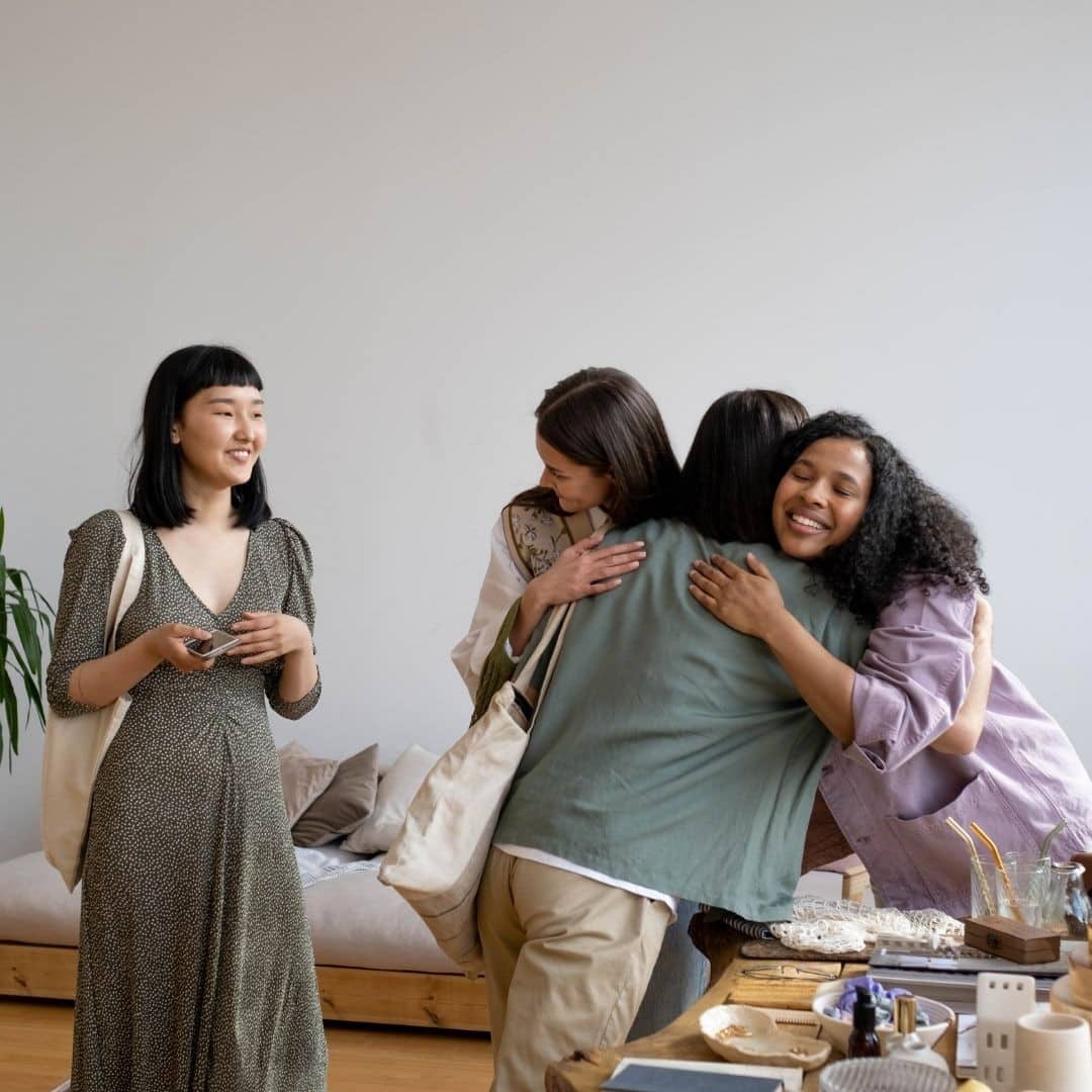 Warm embrace among friends sharing a heartfelt hug.
